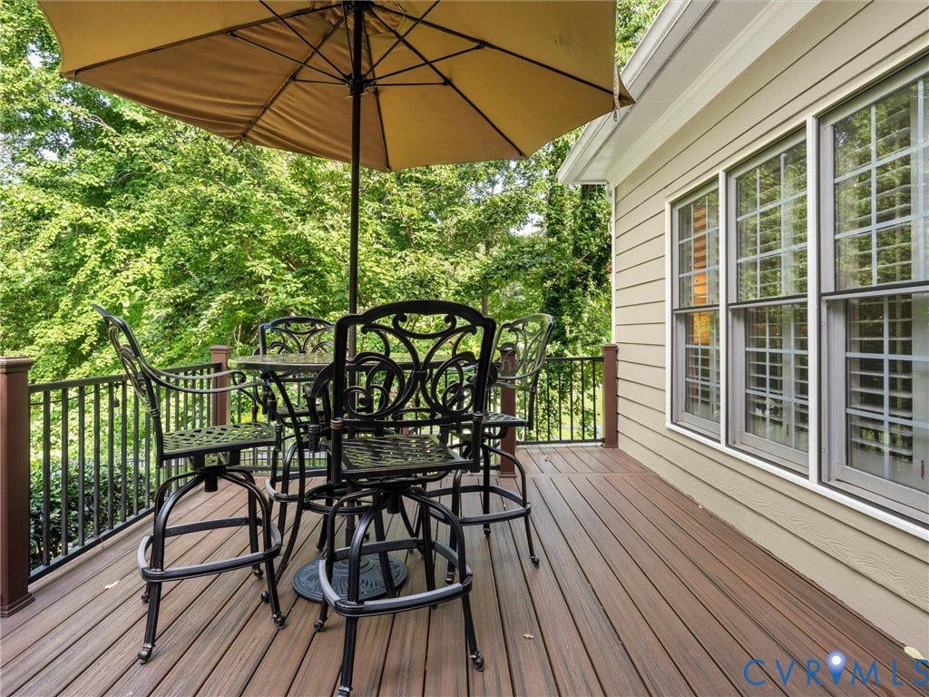15706 Fox Marsh Drive, Moseley, VA 23120 Expansive outdoor deck with wood-finish flooring, black metal railing, and light-colored siding