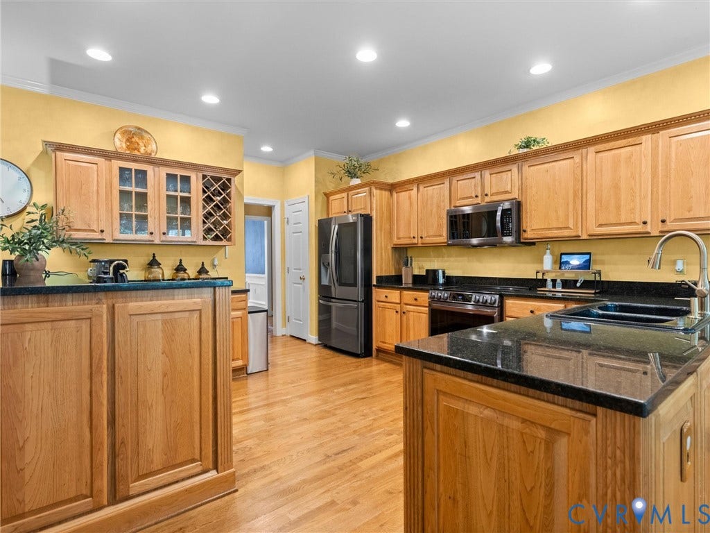 15706 Fox Marsh Drive, Moseley, VA 23120 Kitchen featuring wood cabinetry, black countertops, wood-finish flooring, and recessed lighting