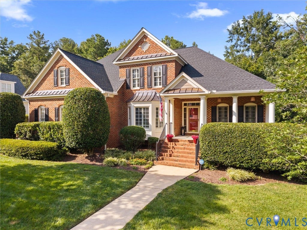 15706 Fox Marsh Drive, Moseley, VA 23120 Brick exterior with gabled roof lines, prominent bay window, and covered front porch with white columns