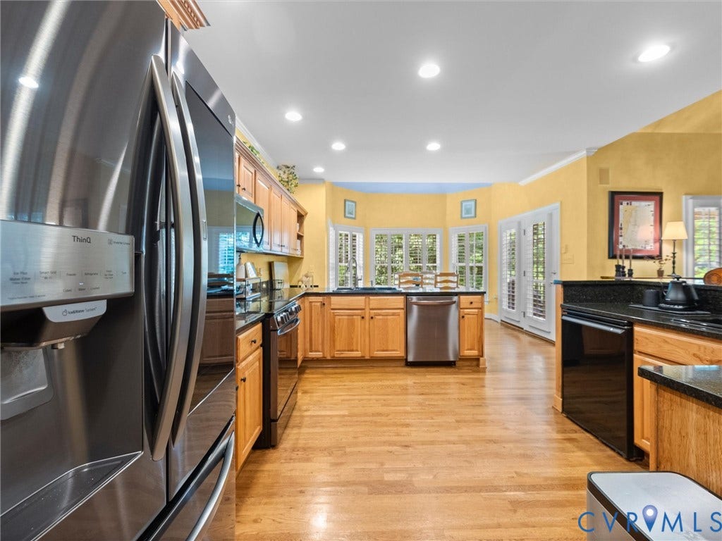 15706 Fox Marsh Drive, Moseley, VA 23120 Kitchen featuring wood-finish flooring, recessed lighting, double doors, stainless steel appliances, and dark countertops