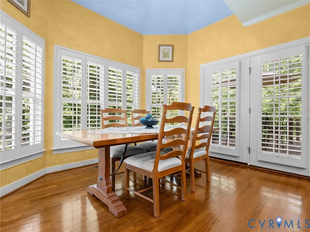 15706 Fox Marsh Drive, Moseley, VA 23120 Hardwood flooring, multiple large windows with white louvered shutters, and white French doors