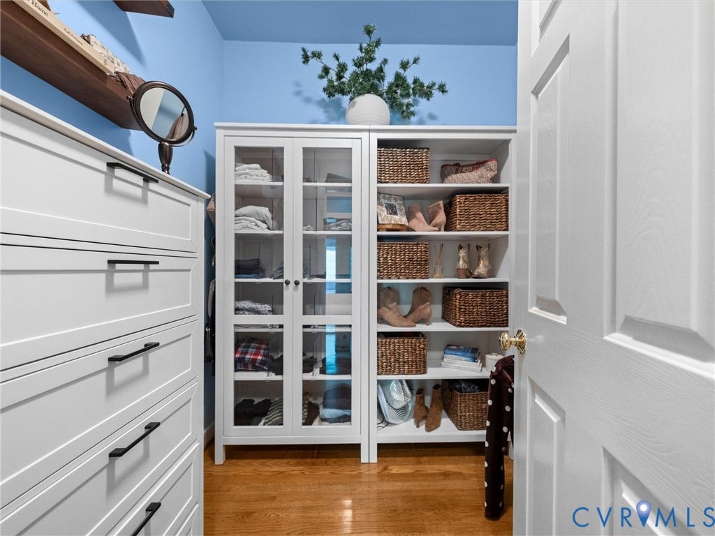 15706 Fox Marsh Drive, Moseley, VA 23120 White built-in cabinetry, glass-front display cabinets, open shelving, and wood-finish flooring