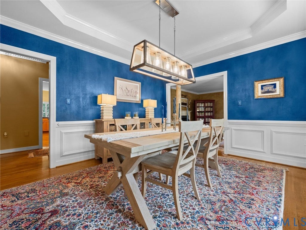 15706 Fox Marsh Drive, Moseley, VA 23120 Tray ceiling with crown molding, wood-finish flooring, wainscoting, and a linear chandelier