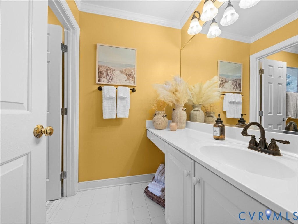 15706 Fox Marsh Drive, Moseley, VA 23120 Vanity featuring a single-bowl sink, bronze-finish faucet, and integrated countertop