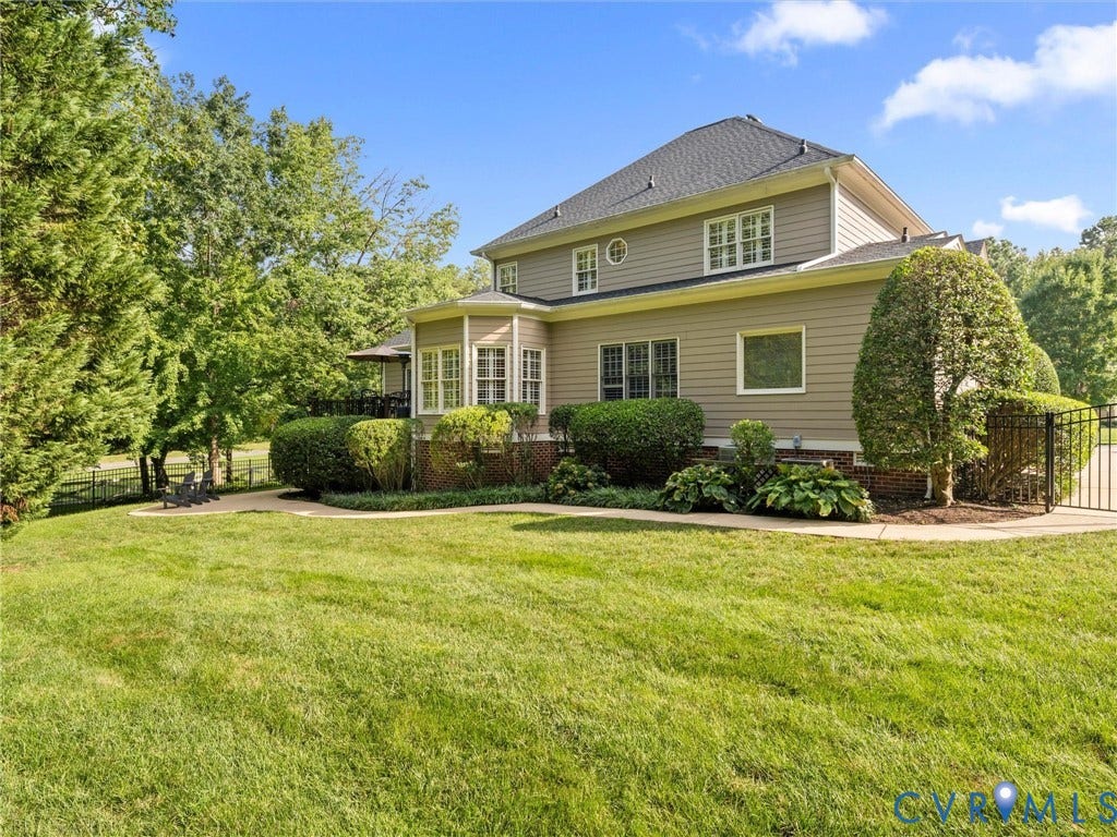 15706 Fox Marsh Drive, Moseley, VA 23120 Expansive rear lawn with mature landscaping, a bay window, and a private patio area