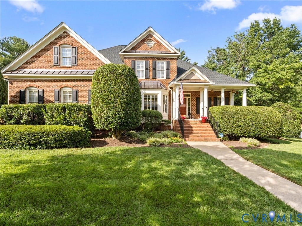 15706 Fox Marsh Drive, Moseley, VA 23120 Brick exterior with white columns, covered front porch, and a gable roof