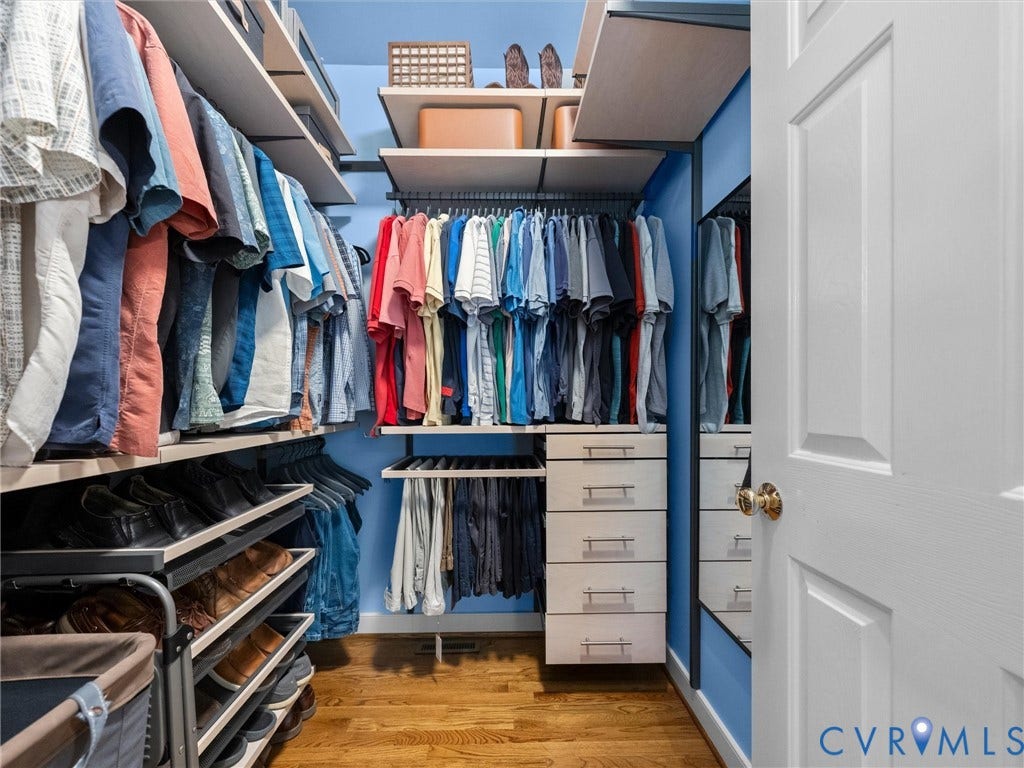 15706 Fox Marsh Drive, Moseley, VA 23120 Integrated custom closet system featuring multiple hanging rods, shelving, shoe racks, and built-in drawers