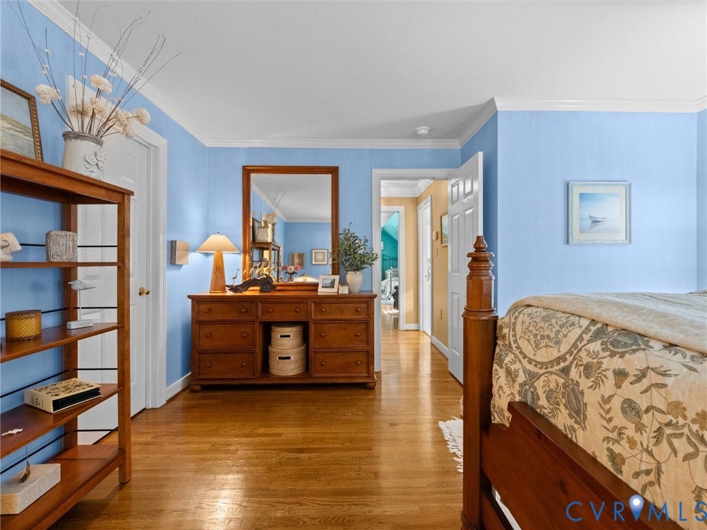 15706 Fox Marsh Drive, Moseley, VA 23120 Hardwood flooring, crown molding, white trim, and a built-in shelving unit