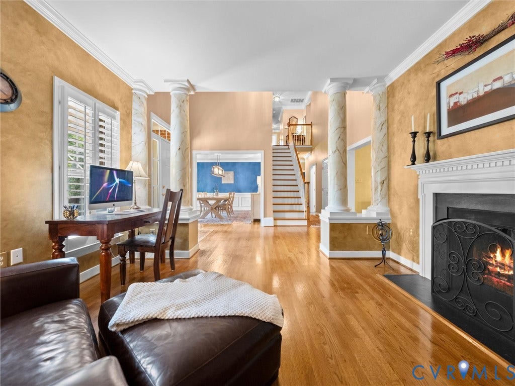 15706 Fox Marsh Drive, Moseley, VA 23120 Hardwood flooring, classic fireplace with mantel, white plantation shutters, decorative columns, and crown molding