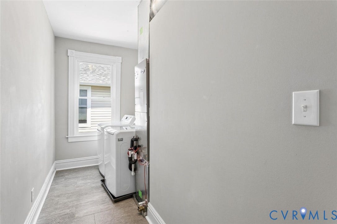 313 W 27th Street, Richmond, VA 23225 Window with white trim, light grey walls, and grey tile flooring
