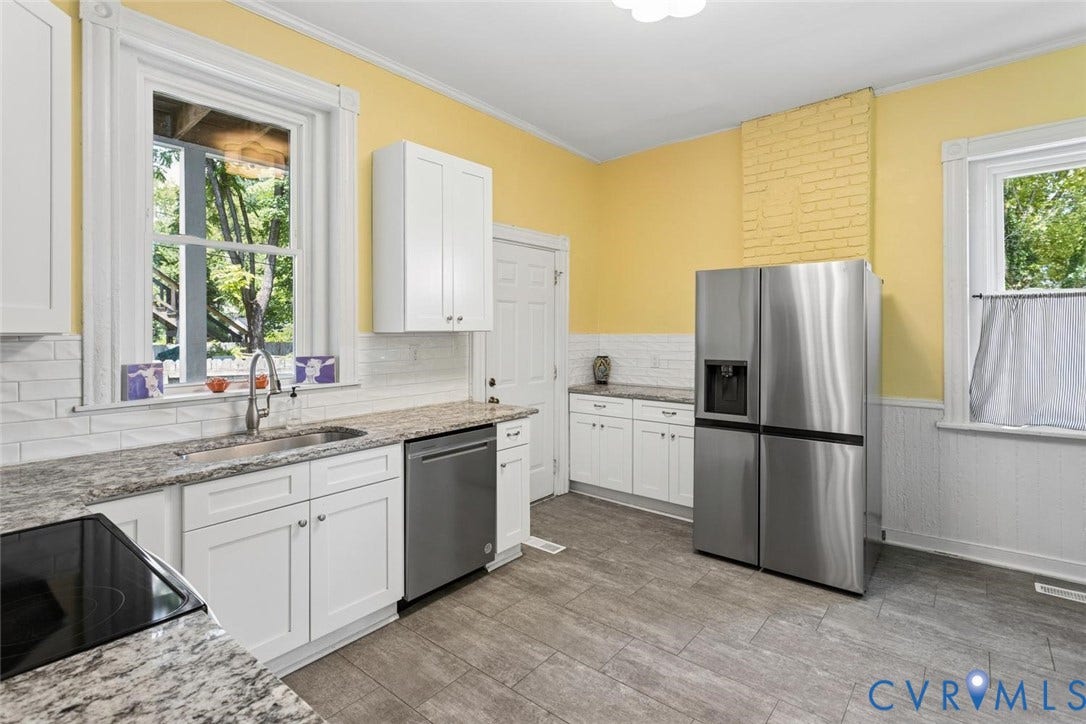 313 W 27th Street, Richmond, VA 23225 White shaker cabinetry, stainless steel dishwasher, and a contemporary stainless steel refrigerator