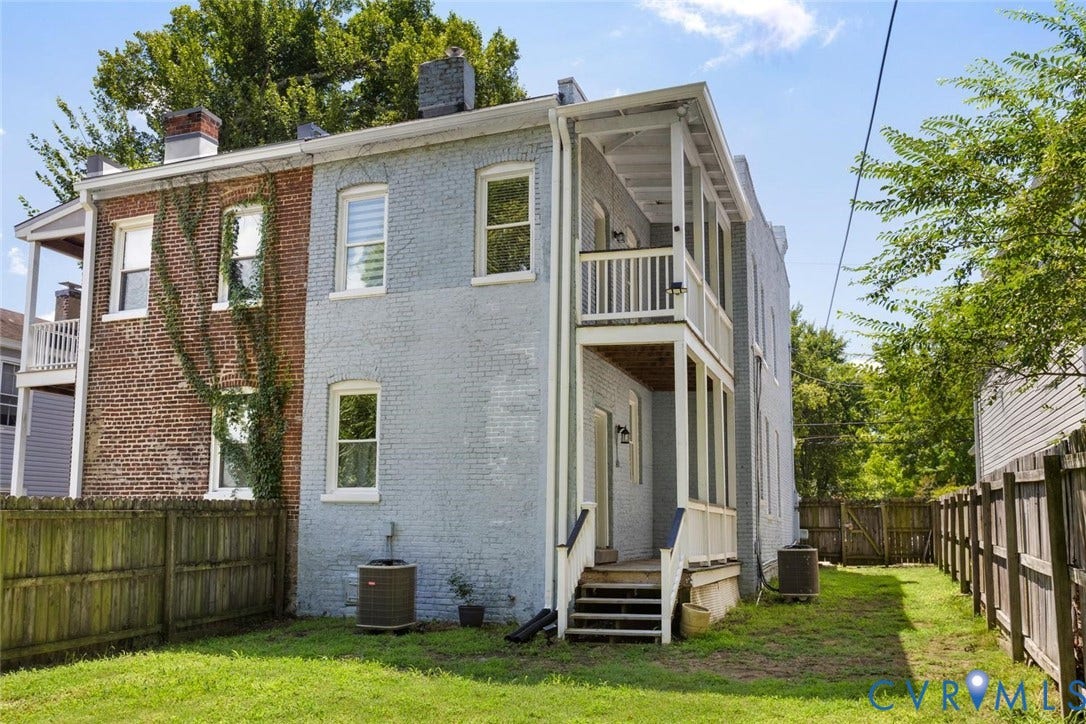 313 W 27th Street, Richmond, VA 23225 Expansive grassy yard with wood fencing and multi-level rear porches