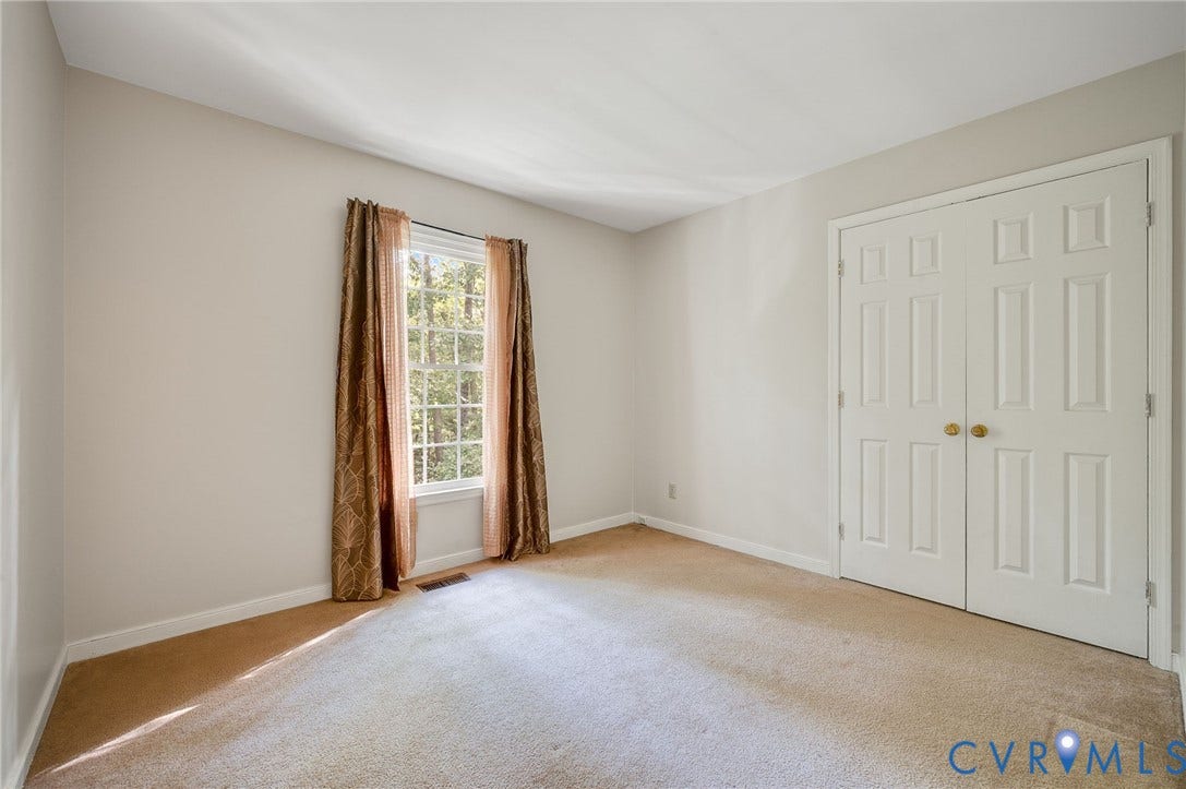 4820 Cedar Cliff Road, Chester, VA 23831 Carpeted flooring, neutral wall tones, large window, and double bi-fold doors