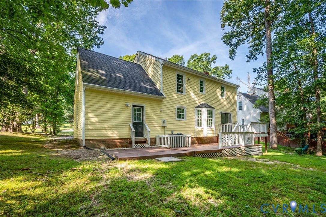 4820 Cedar Cliff Road, Chester, VA 23831 Rear elevation with yellow siding, multi-level wood deck, and bay window