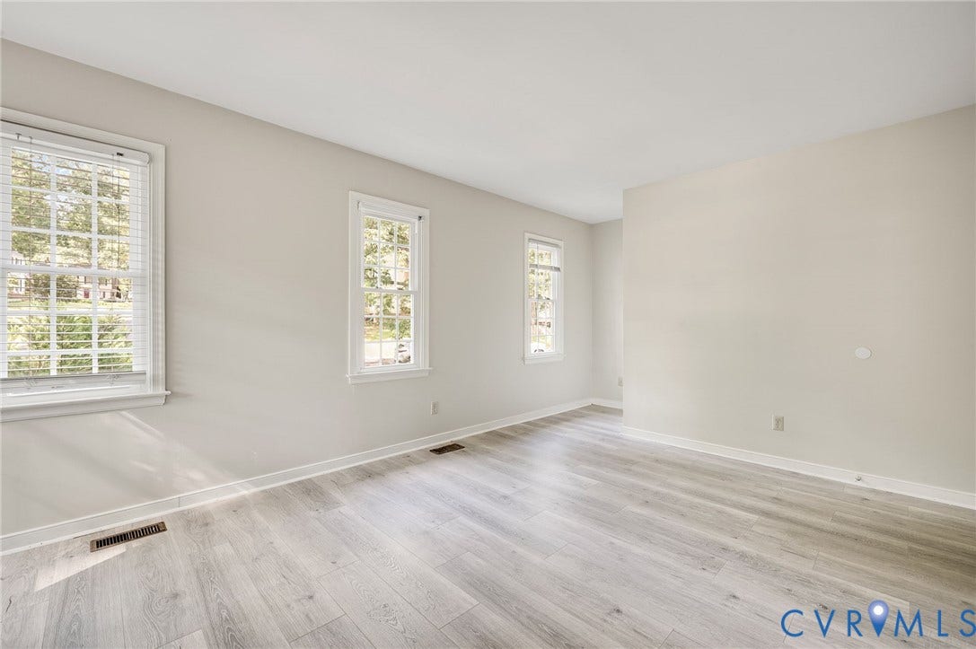 4820 Cedar Cliff Road, Chester, VA 23831 Light-toned wood-finish flooring, multiple windows, and neutral wall tones