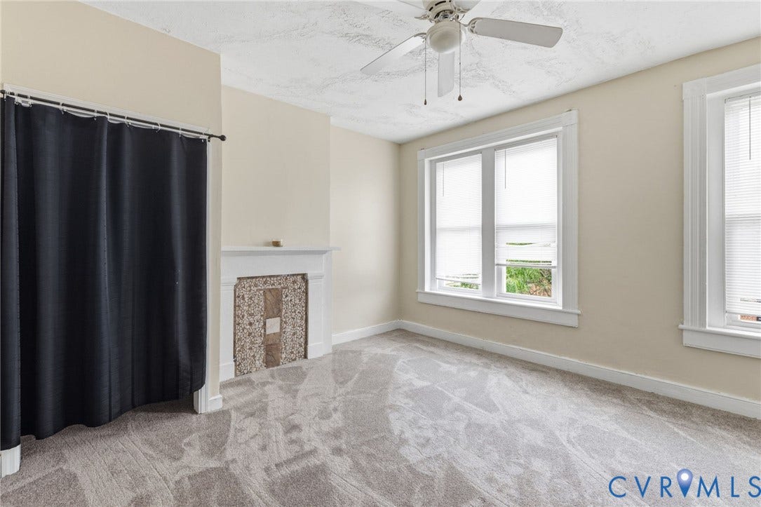 1202 1/2 W Clay Street, Richmond, VA 23220 Light-colored walls, textured ceiling, ceiling fan, white window trim, and patterned carpet flooring