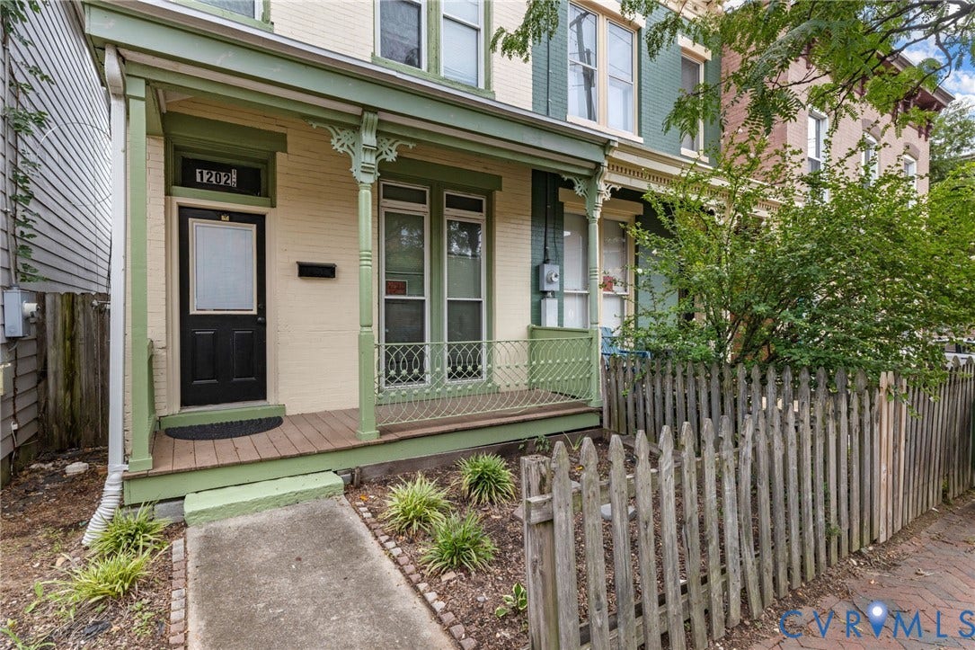 1202 1/2 W Clay Street, Richmond, VA 23220 Front porch with wood-finish flooring, decorative porch railing, and a black entry door