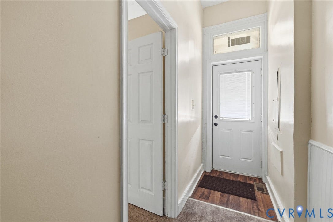 1202 1/2 W Clay Street, Richmond, VA 23220 White paneled door with glass insert, transom window, and wood-finish flooring