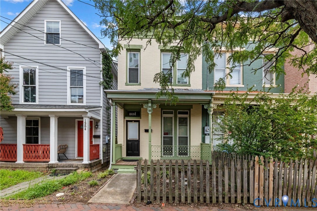1202 1/2 W Clay Street, Richmond, VA 23220 Two-story facade with light-colored siding and dark trim