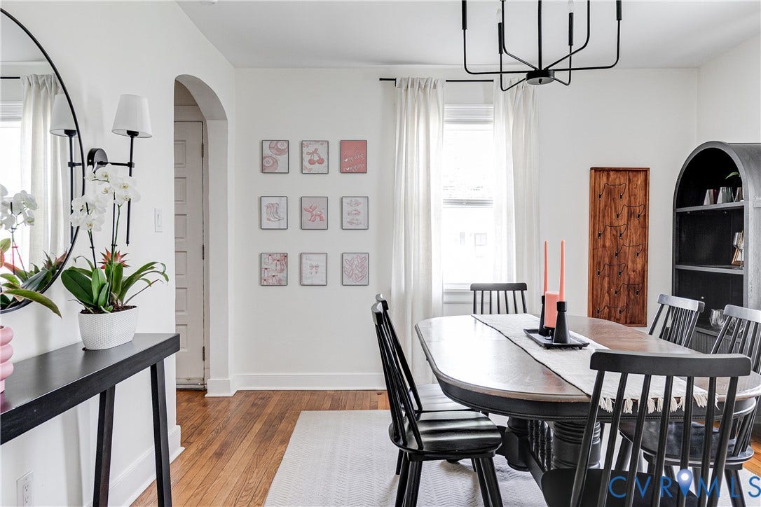 3215 Detroit Avenue, Richmond, VA 23222 Elegant dining space featuring hardwood flooring, a black metal chandelier, and arched doorways with deep soffits