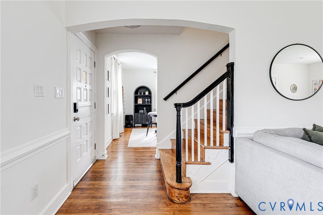 3215 Detroit Avenue, Richmond, VA 23222 Hardwood flooring, painted paneled entry door, arched doorway, and a staircase with painted newel posts and spindles