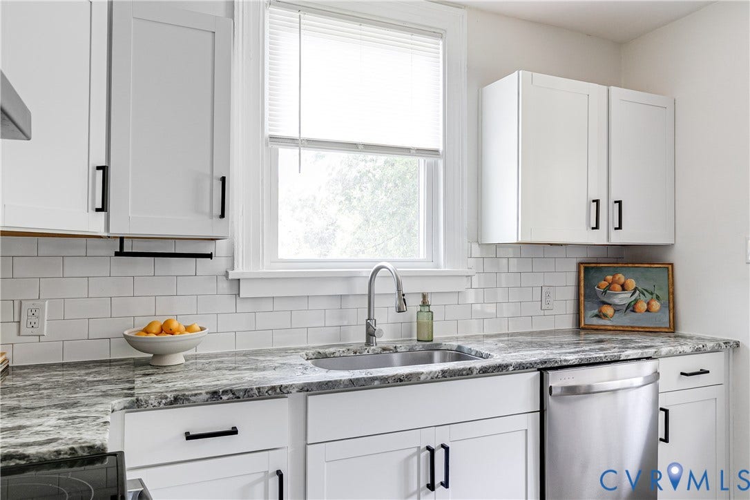 3215 Detroit Avenue, Richmond, VA 23222 White shaker-style cabinetry with matte black hardware, subway tile backsplash, stainless steel sink with gooseneck faucet, light-colored countertops, and stainless steel dishwasher