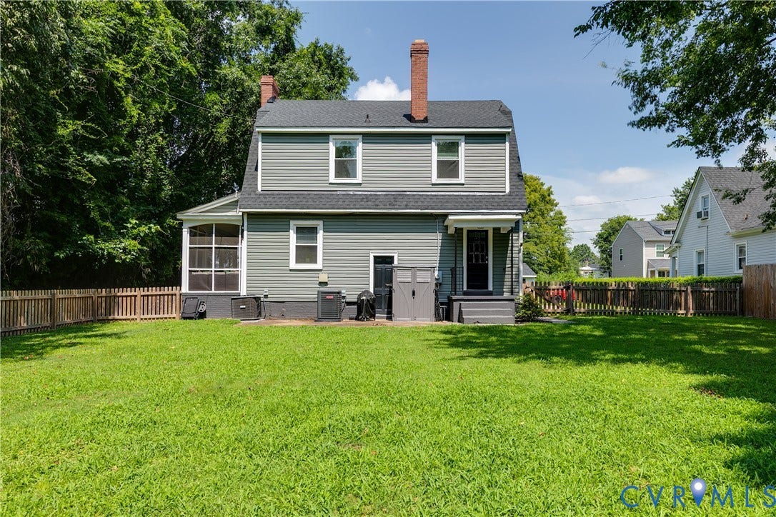 3215 Detroit Avenue, Richmond, VA 23222 Expansive lawn, privacy fencing, gray siding exterior, screened-in porch, and rear entry