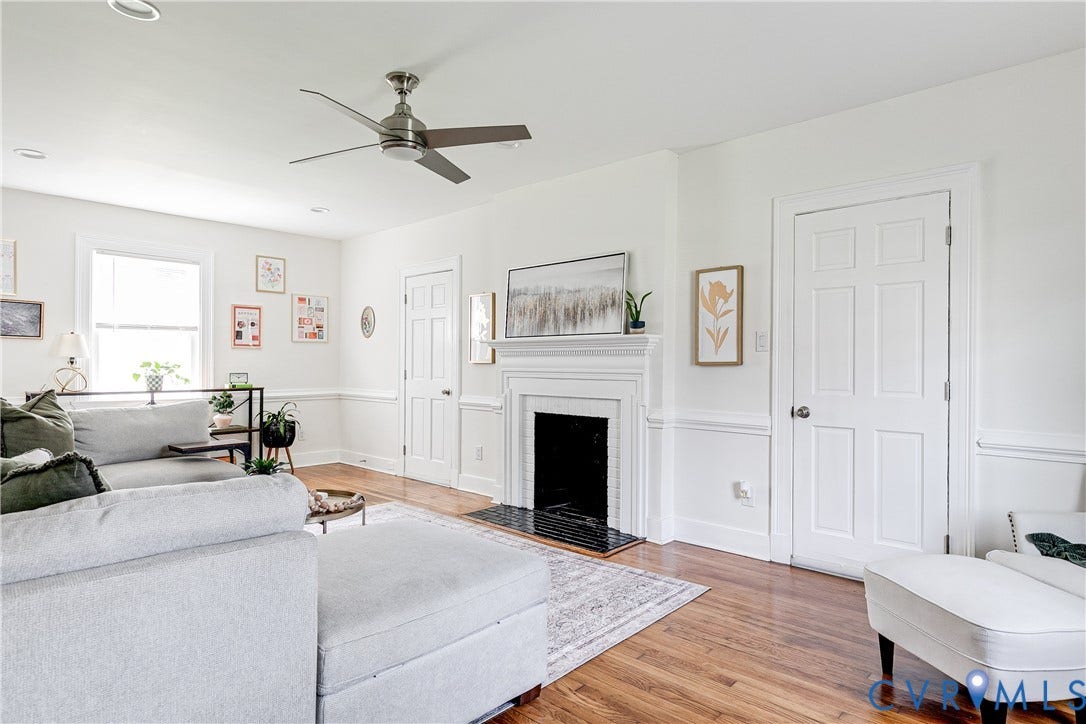 3215 Detroit Avenue, Richmond, VA 23222 Hardwood flooring, white fireplace with dark hearth, ceiling fan, crown molding, and window with natural light