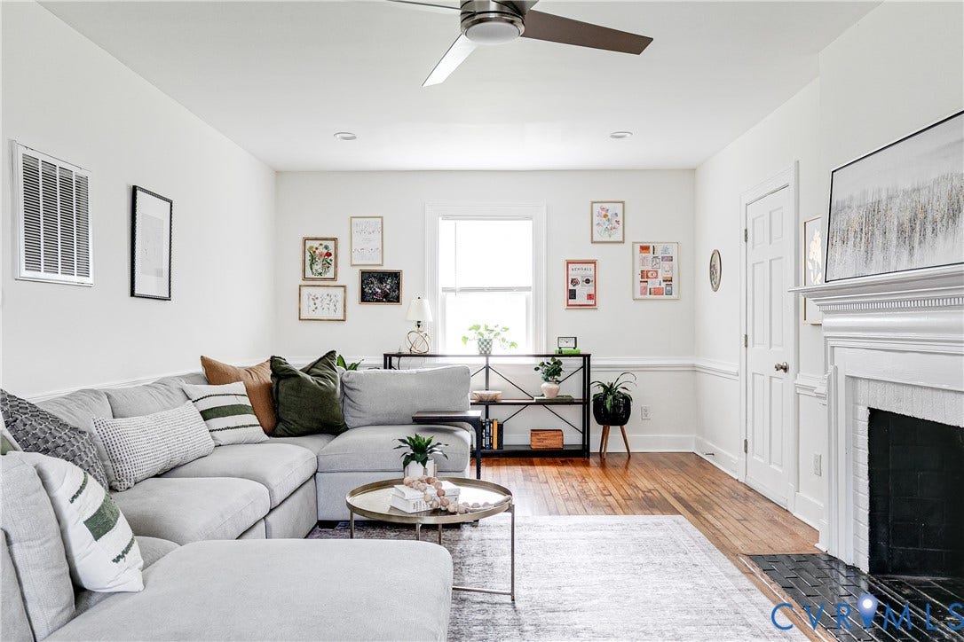 3215 Detroit Avenue, Richmond, VA 23222 Hardwood flooring, white painted walls, decorative wainscoting, white window trim, and a ceiling fan with integrated lighting