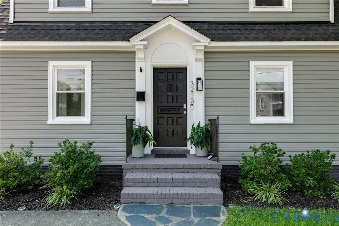 3215 Detroit Avenue, Richmond, VA 23222 Gray horizontal siding with white trim, dark entry door with transom detail, and gray brick steps