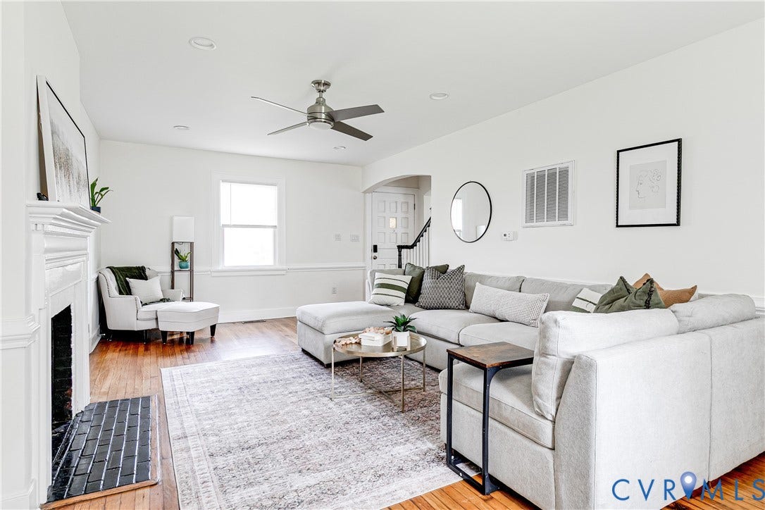 3215 Detroit Avenue, Richmond, VA 23222 Hardwood-finish flooring, white painted walls, decorative fireplace with black tile hearth, recessed lighting, and a ceiling fan
