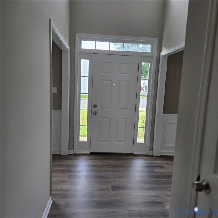 3241 Ransom Hills Road, Chesterfield, VA 23237 Entryway featuring a paneled door with sidelights and transom window, wood-finish flooring, and wainscoting