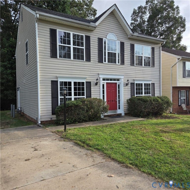 3241 Ransom Hills Road, Chesterfield, VA 23237 Two-story residence featuring light-colored siding, contrasting dark shutters, and a vibrant red entry door