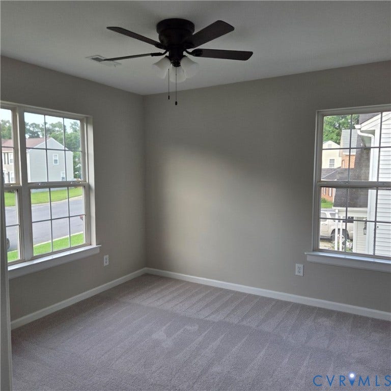 3241 Ransom Hills Road, Chesterfield, VA 23237 Neutral wall paint, ceiling fan with integrated lighting, two windows with grid patterns, and plush carpet flooring
