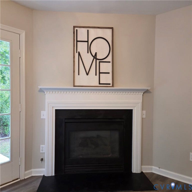 3241 Ransom Hills Road, Chesterfield, VA 23237 Elegant fireplace with crisp white surround and dentil molding detail, complemented by dark firebox and hearth