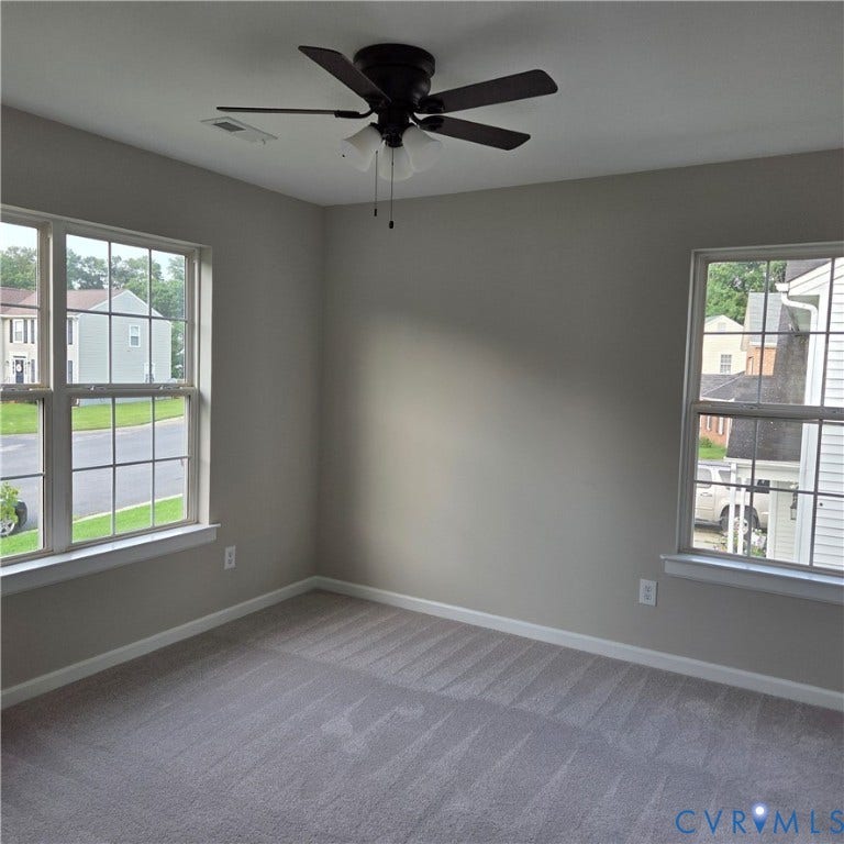 3241 Ransom Hills Road, Chesterfield, VA 23237 Neutral wall tones, gray carpeting, a ceiling fan with integrated lighting, and two windows with grid patterns
