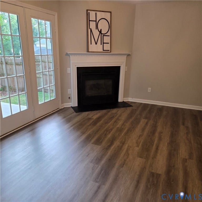3241 Ransom Hills Road, Chesterfield, VA 23237 Fireplace with a white mantel, wood-finish flooring, and double French doors opening to a patio
