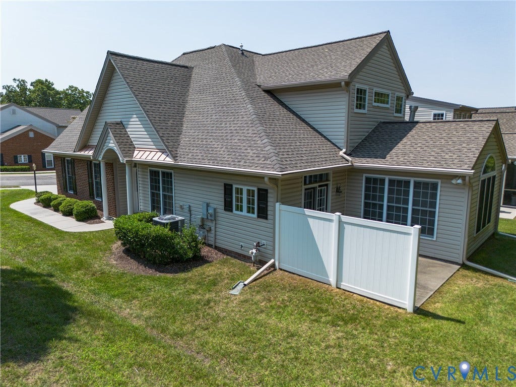 5046 Lewisetta Drive, Carriage Homes II Crossridge, Glen Allen, VA 23060 Siding exterior with multiple window styles, concrete patio, and a white privacy fence