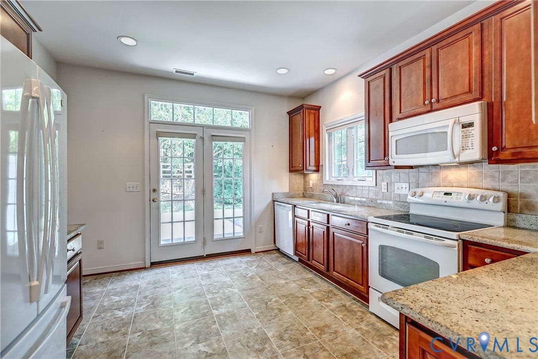 5046 Lewisetta Drive, Carriage Homes II Crossridge, Glen Allen, VA 23060 Kitchen featuring wood cabinetry, granite countertops, tile flooring, and French doors with transom windows