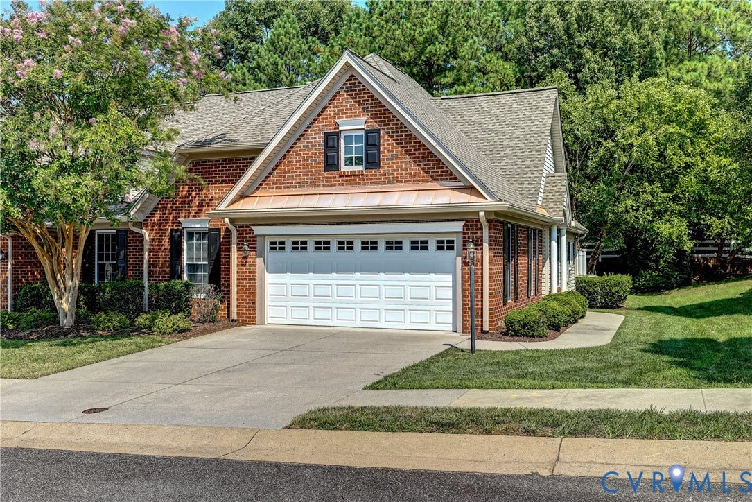 5046 Lewisetta Drive, Carriage Homes II Crossridge, Glen Allen, VA 23060 Brick exterior with white garage door, concrete driveway, and mature landscaping