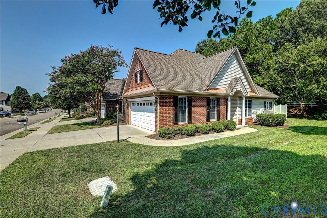 5046 Lewisetta Drive, Carriage Homes II Crossridge, Glen Allen, VA 23060 Brick and siding exterior with a gabled roofline, attached two-car garage, and established front landscaping
