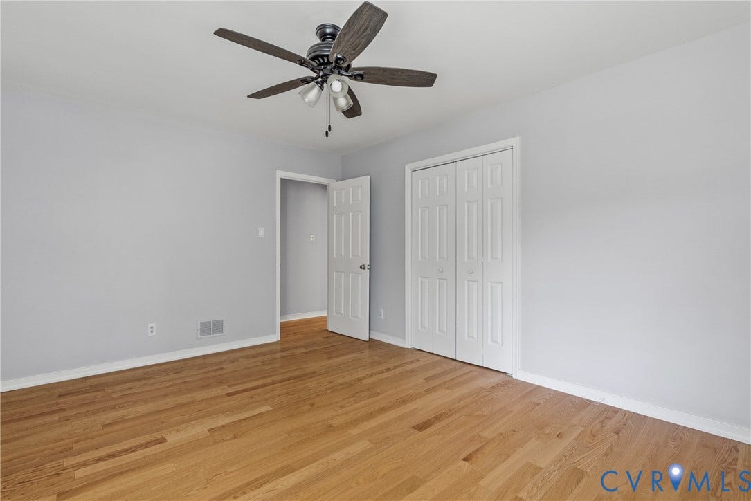 3242 Sherwood Ridge Drive, Powhatan, VA 23139 Hardwood flooring, light gray wall finishes, white trim, ceiling fan with integrated lighting, and white bi-fold closet doors