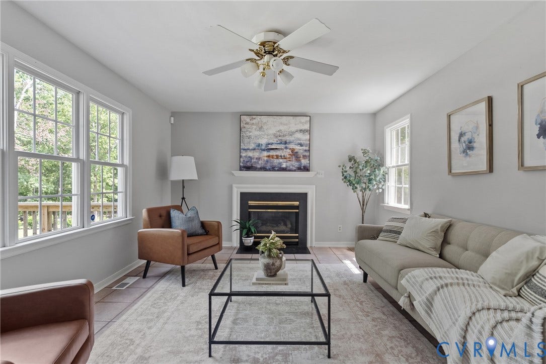 3242 Sherwood Ridge Drive, Powhatan, VA 23139 Hardwood-style flooring, white trim windows, white mantel, black fireplace surround, and a ceiling fan