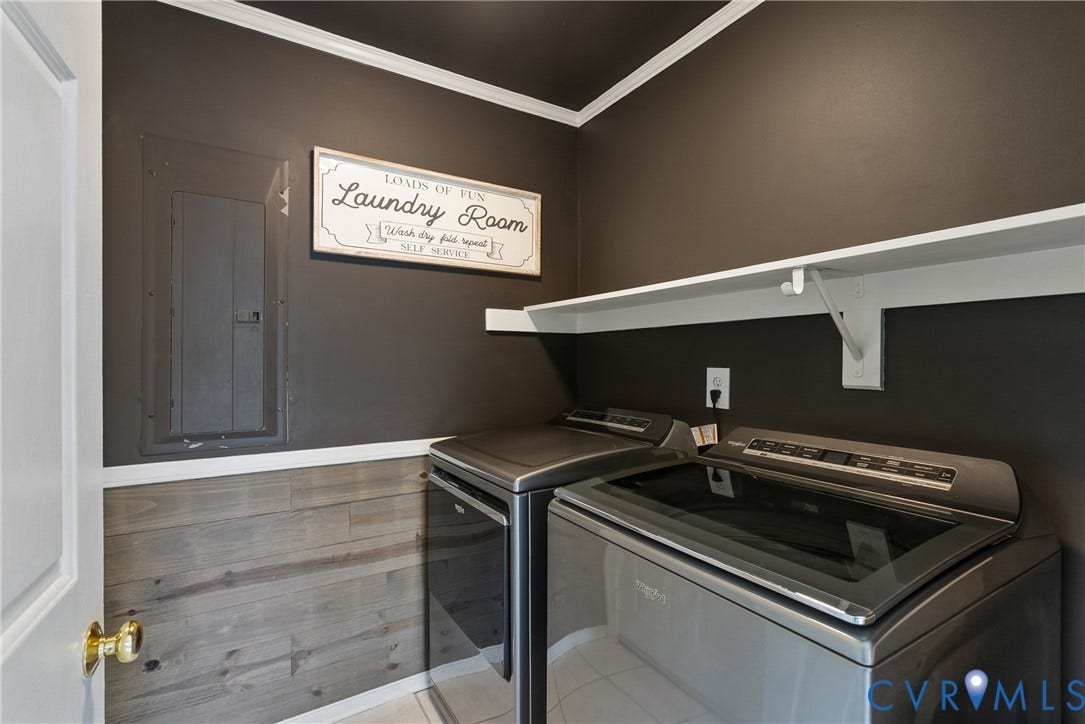 3242 Sherwood Ridge Drive, Powhatan, VA 23139 Laundry area featuring a wood-finish accent wall, dark painted walls, white crown molding, and a white built-in shelf