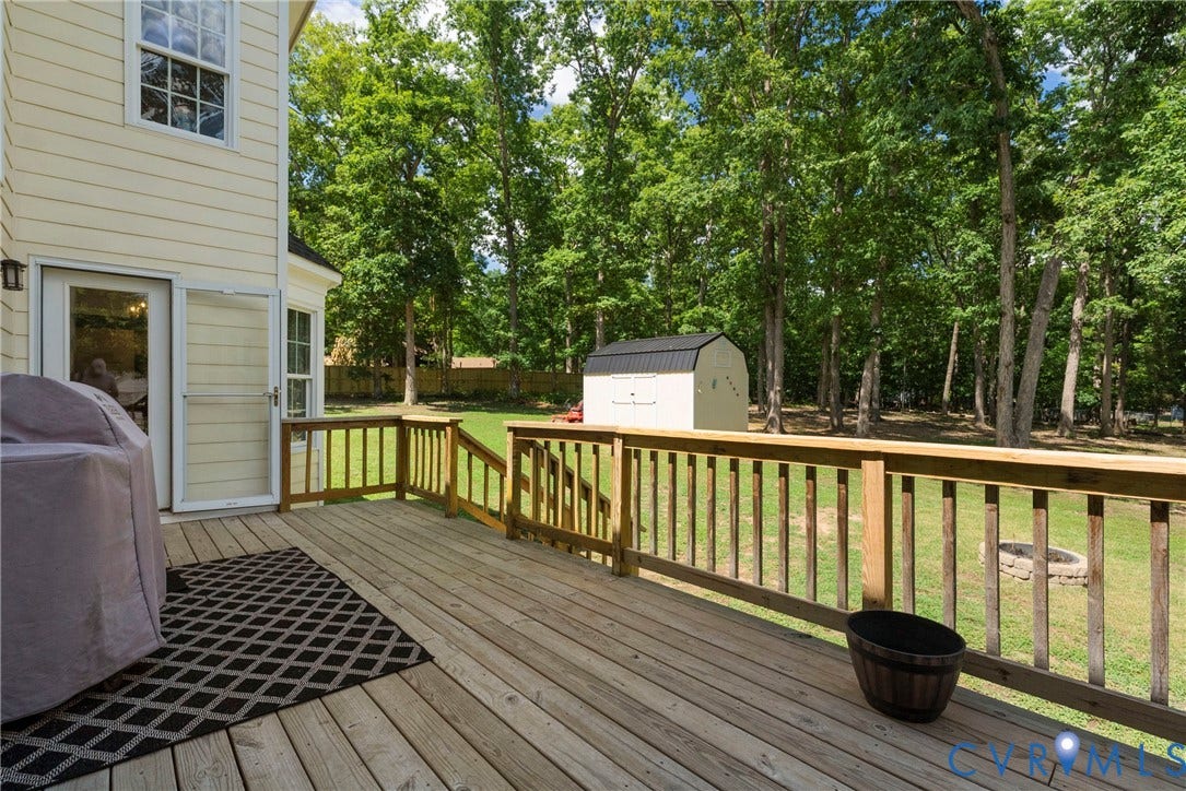 3242 Sherwood Ridge Drive, Powhatan, VA 23139 Expansive wood deck with natural wood railing, offering a direct walkout