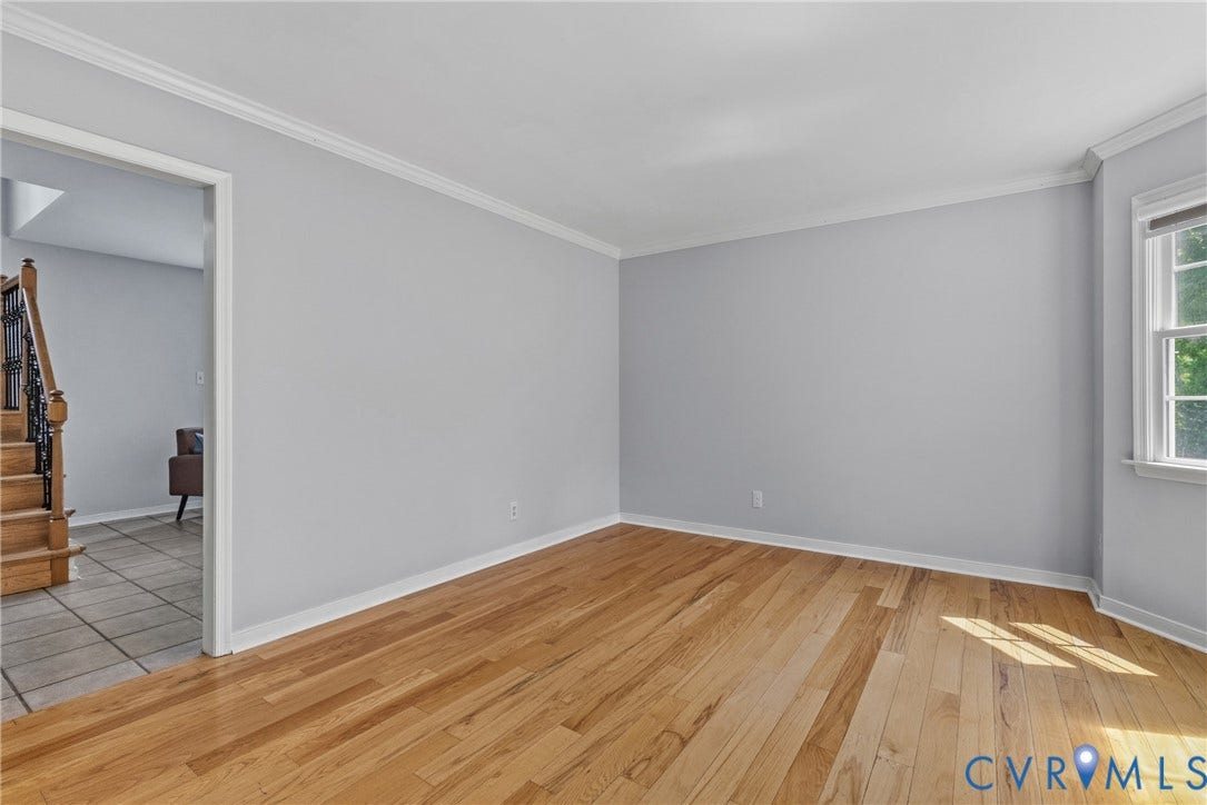 3242 Sherwood Ridge Drive, Powhatan, VA 23139 Hardwood flooring, painted walls, white trim, and a window with white casing
