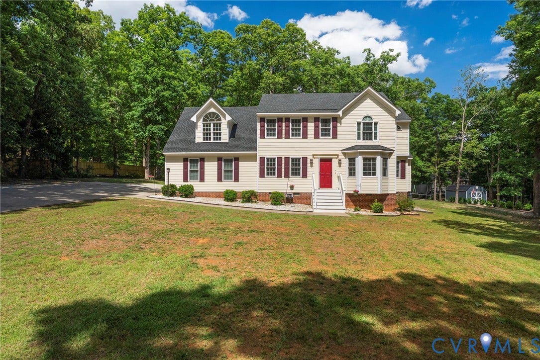 3242 Sherwood Ridge Drive, Powhatan, VA 23139 Two-story colonial residence with light-colored siding, dark shutters, and a prominent red entry door