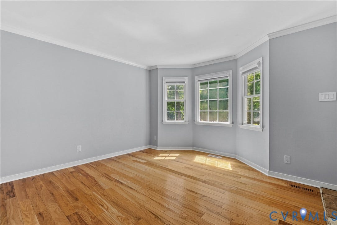3242 Sherwood Ridge Drive, Powhatan, VA 23139 Hardwood flooring with a bay window featuring multiple pane windows and crown molding