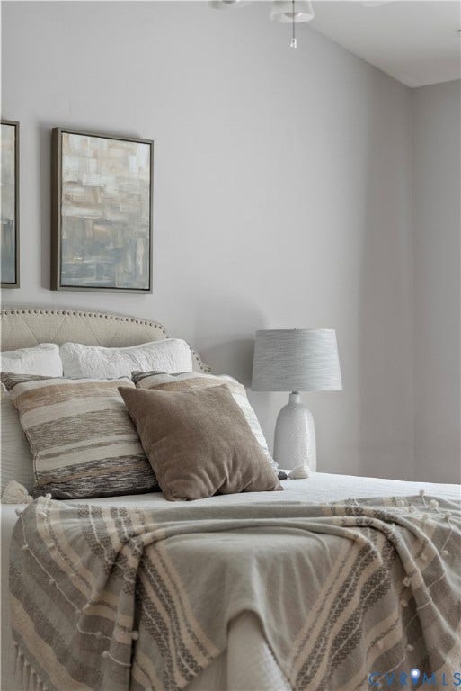 3242 Sherwood Ridge Drive, Powhatan, VA 23139 Upholstered headboard with tufting, framed wall art, and an attached ceiling light fixture