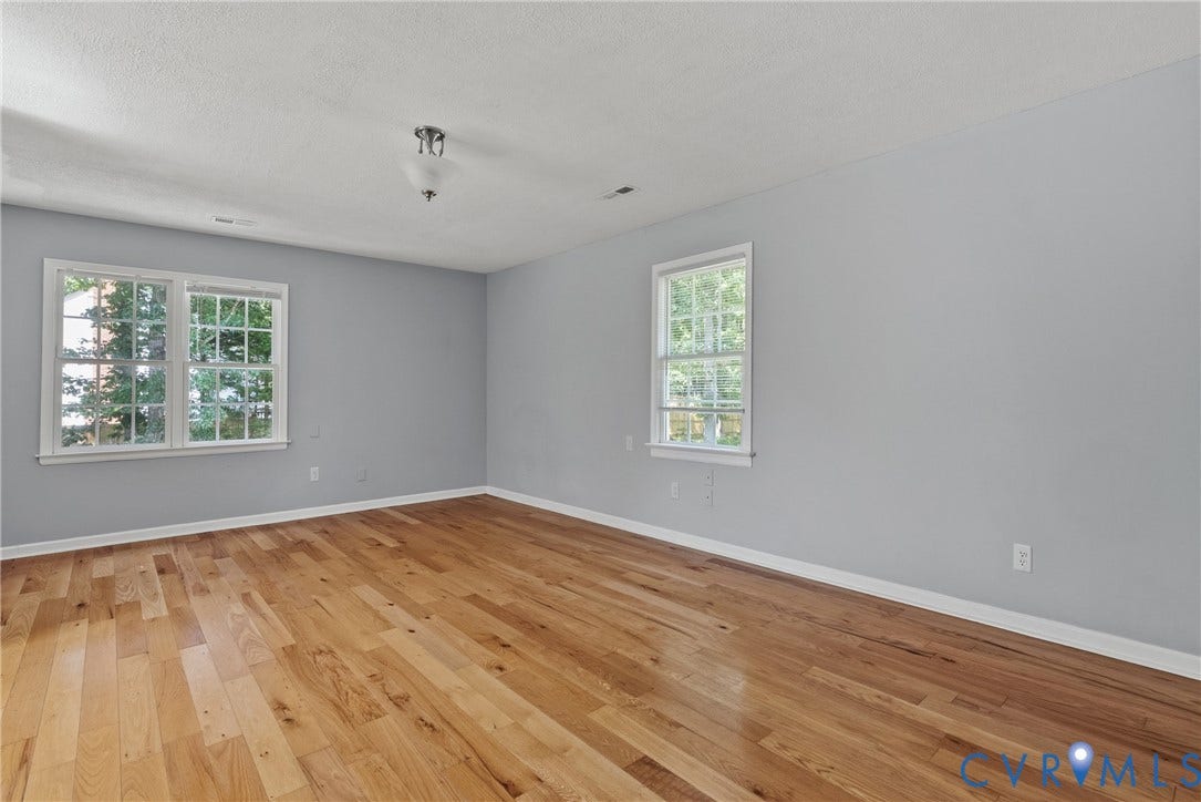 3242 Sherwood Ridge Drive, Powhatan, VA 23139 Hardwood flooring and light gray walls complement natural light from multiple windows